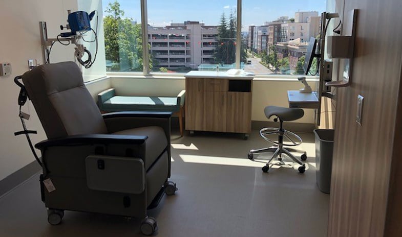 An interior of a healthcare facility featuring medical chairs and various equipment.