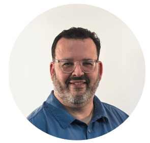 A professional headshot of Darren Swift.