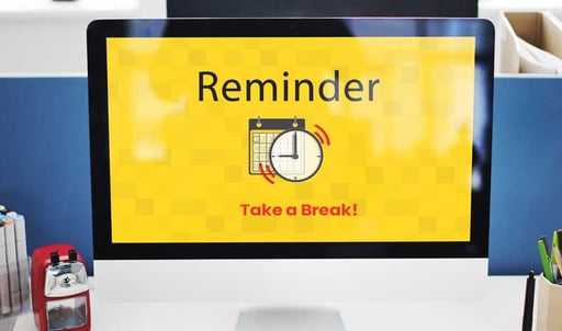 A computer screen displaying a "Reminder" message with a timer icon, suggesting it is a break reminder.