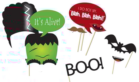 Halloween photo booth props including speech bubbles, mustaches, and character cutouts.