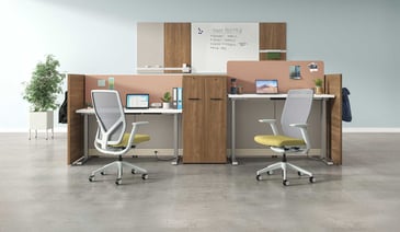 A modern workstation with ergonomic chairs, adjustable tables, wooden dividers, and storage in a minimalist open space.
