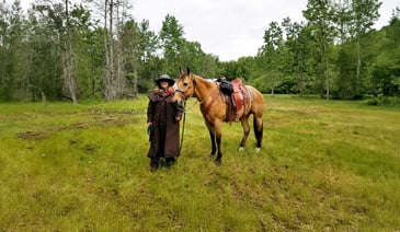 Marlaine McCauley smiling while holding a horse.