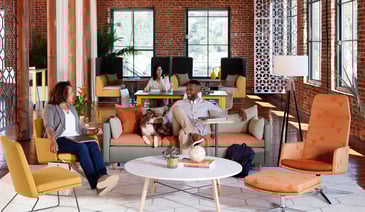 Team collaborating in modern office lounge with colorful modular seating.