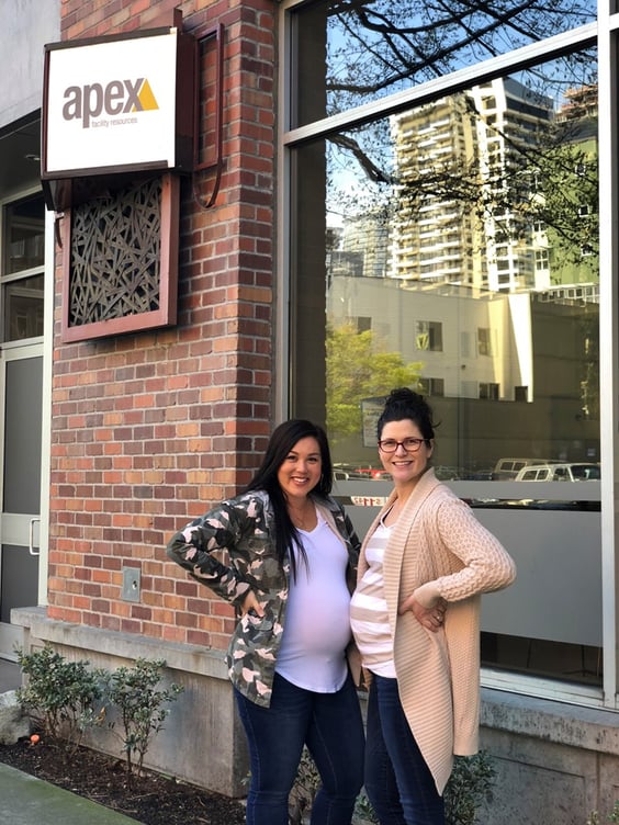 Two pregnant women standing outside Apex building.