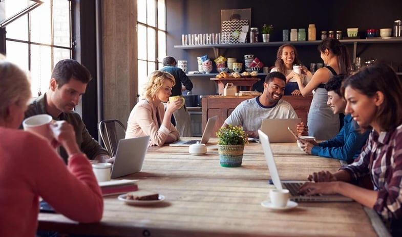 A group of employees working over coffee .