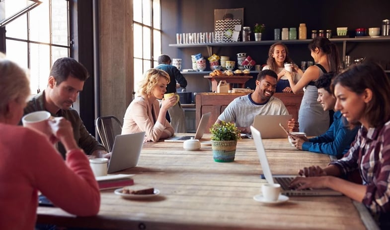 A group of employees working over coffee . 