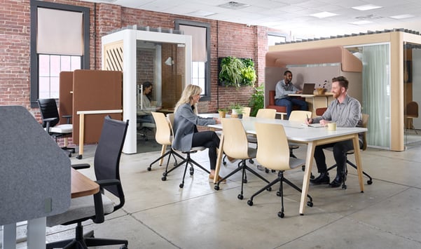 A dynamic blended office space where individuals collaborate while also enjoying focused, private work moments.