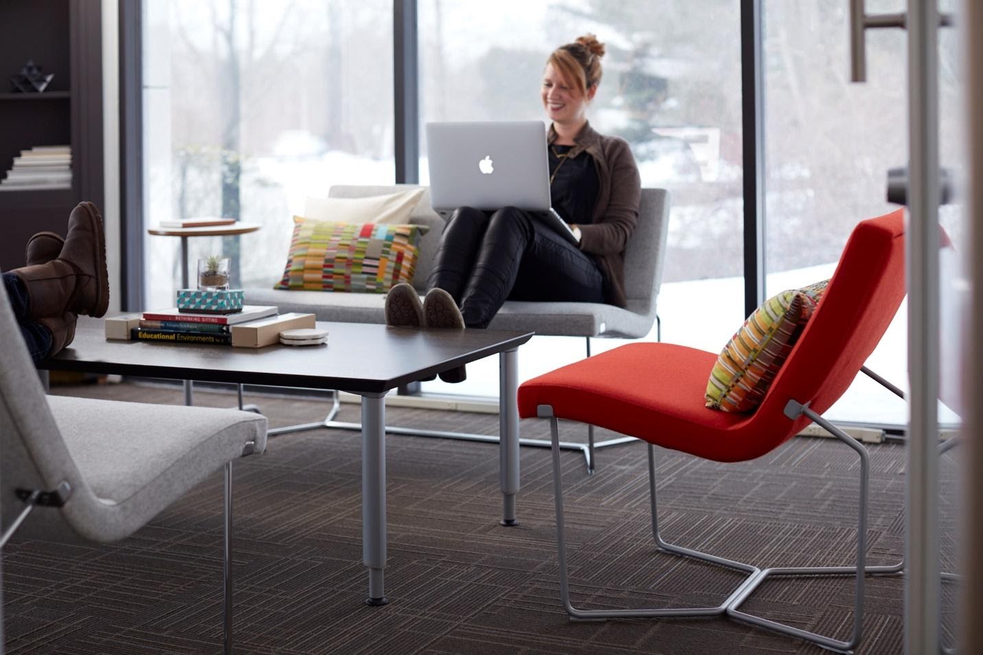 Person working on laptop on lounge area